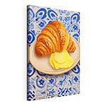 Vászonképek Egy tányéron egy croissant és egy sárga folyadék