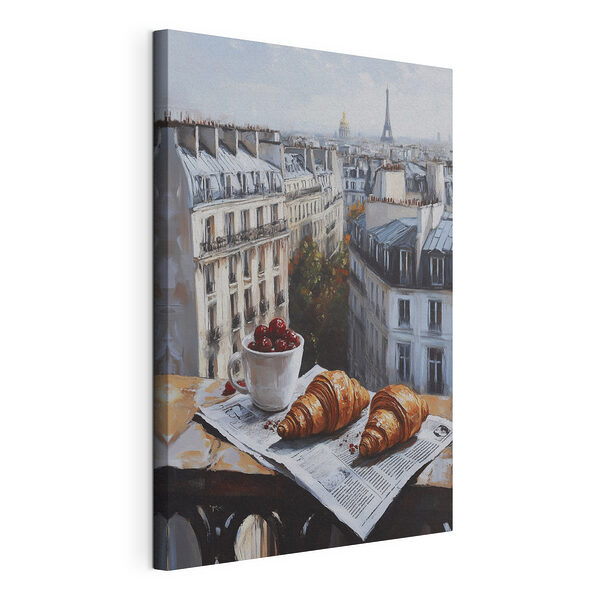 Vászonképek Egy csésze kávé és croissantok egy asztalon, háttérben épületekkel